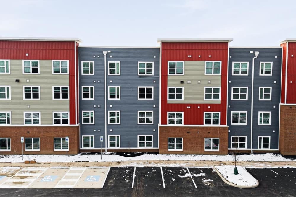 Colorful apartment building with multiple windows and accessible parking spaces at Granville Woods Lofts in Columbus, Ohio