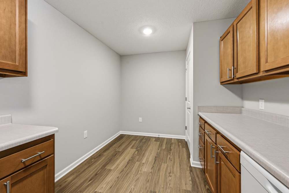 Modern kitchen with wood-style flooring and wooden cabinets at Granville Woods Lofts in Columbus, Ohio