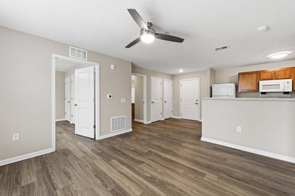 Open layout with wood-style flooring, modern kitchen, and bright living space at Granville Woods Lofts in Columbus, Ohio