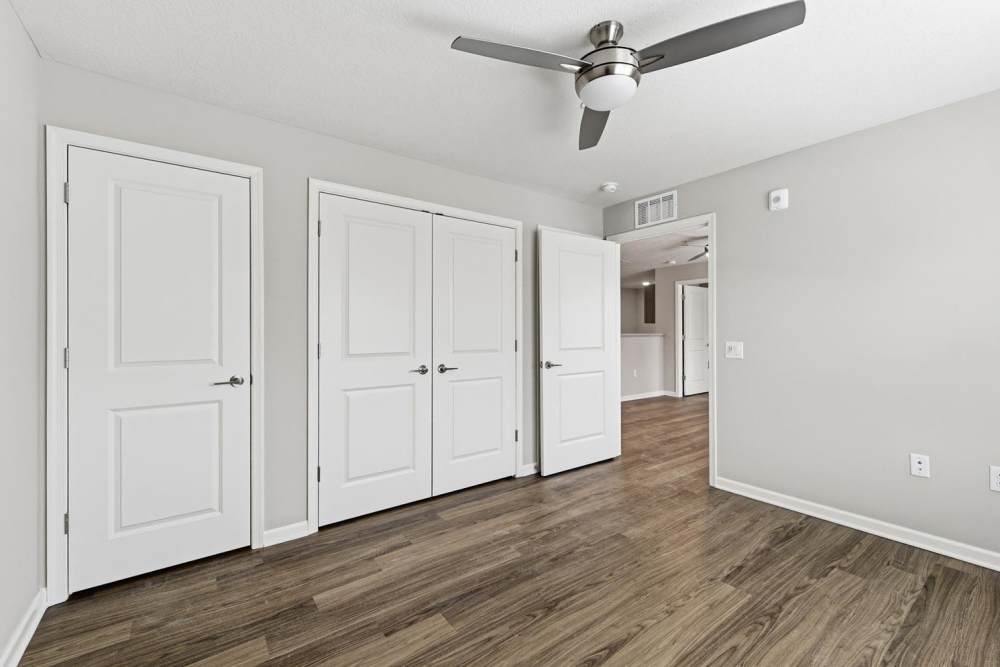 Spacious room with wood-style flooring and ceiling fan at Granville Woods Lofts in Columbus, Ohio