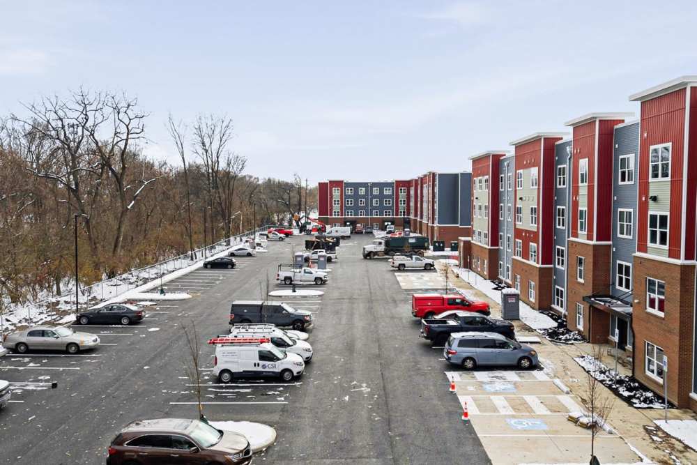 Apartment community with modern buildings and parking lot at Granville Woods Lofts in Columbus, Ohio