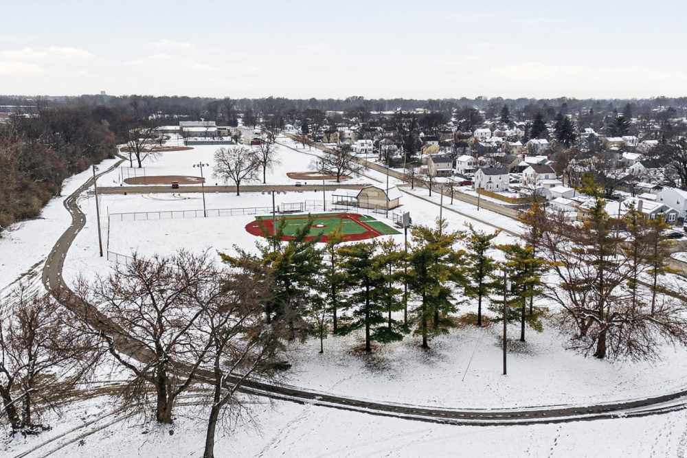 Snow-covered park with baseball field at Granville Woods Lofts in Columbus, Ohio