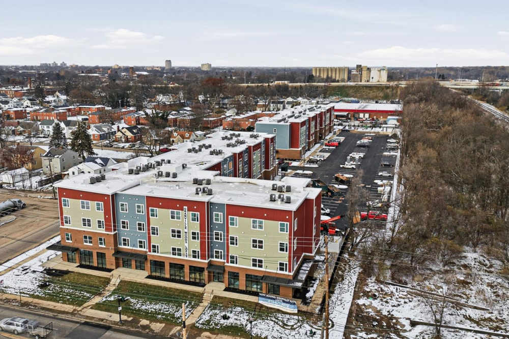 Modern apartment community with colorful exteriors and ample parking spaces at Granville Woods Lofts in Columbus, Ohio