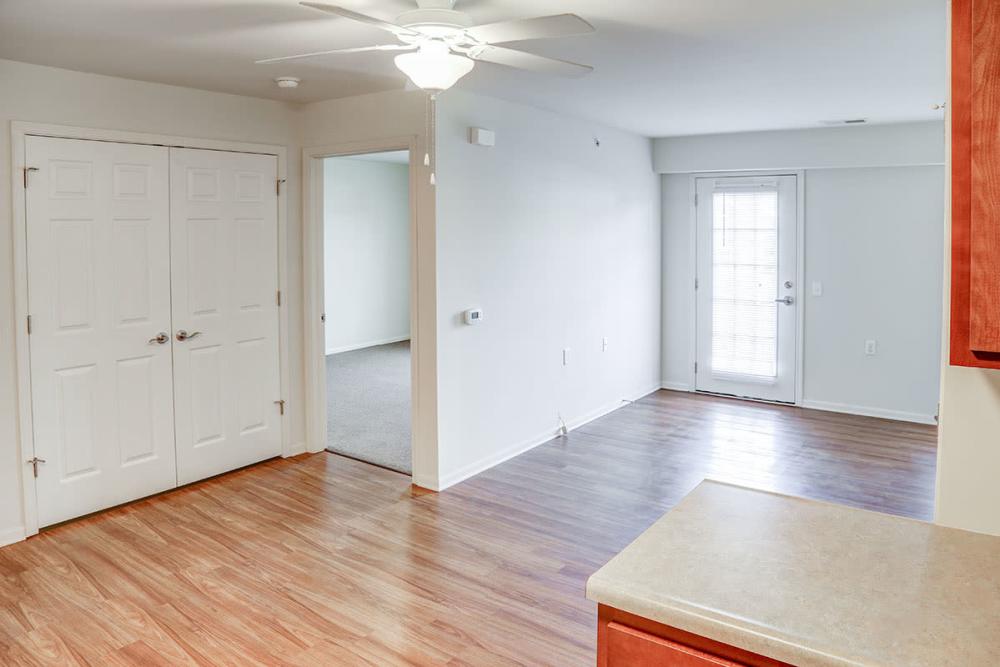 Open layout with wood-style flooring and ceiling fan and featuring a patio door at Hayden House in Springfield, Ohio