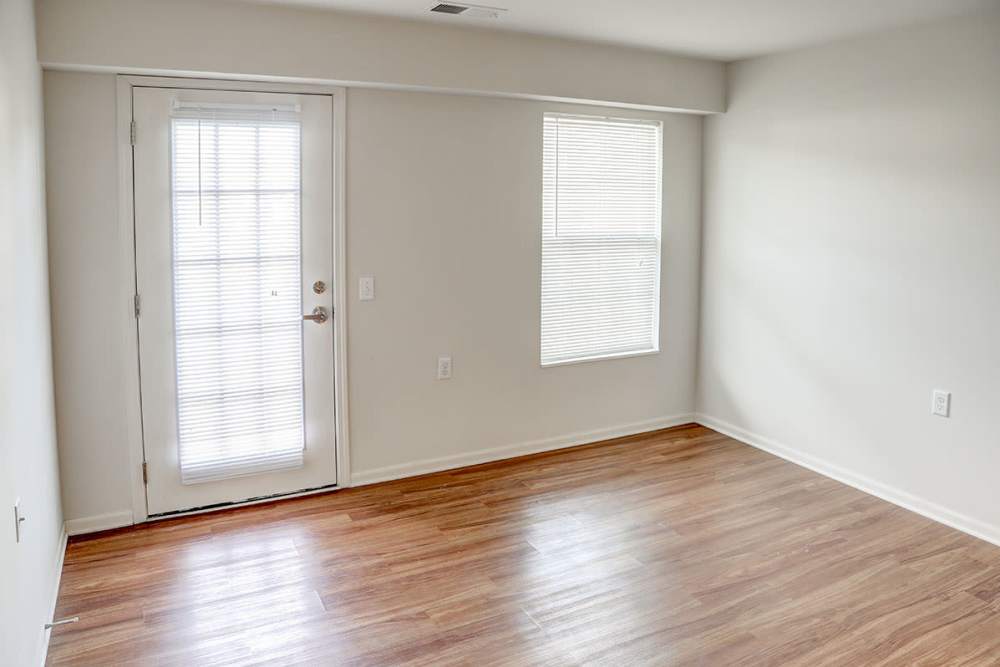 Bright living area with wood-style flooring at Hayden House in Springfield, Ohio