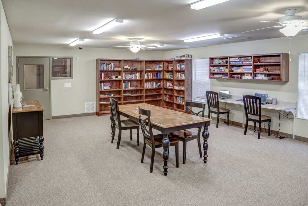 Community room with a large table, bookshelves, and two workstations with computers at Hayden House in Springfield, Ohio