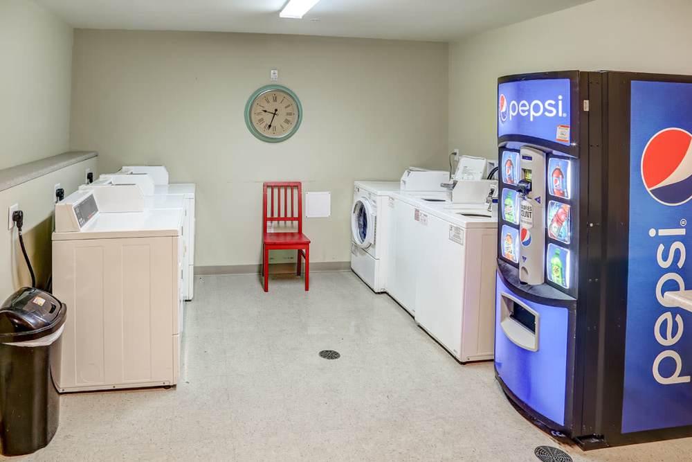 Laundry room with white machines at Hayden House in Springfield, Ohio
