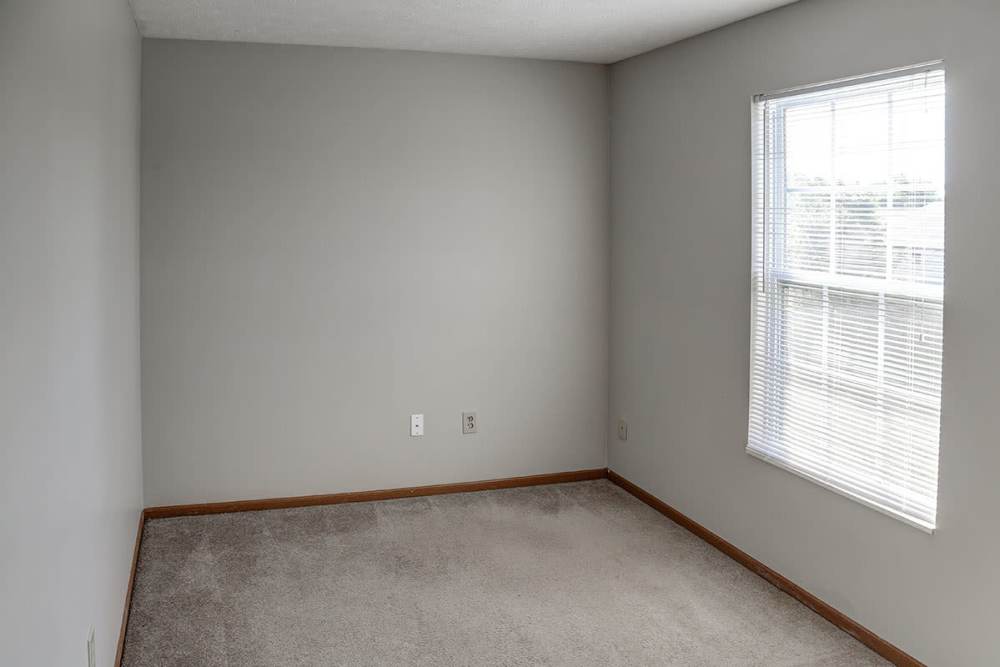 Cozy bedroom with a large window at Ivy Glen in Washington Court House, Ohio 