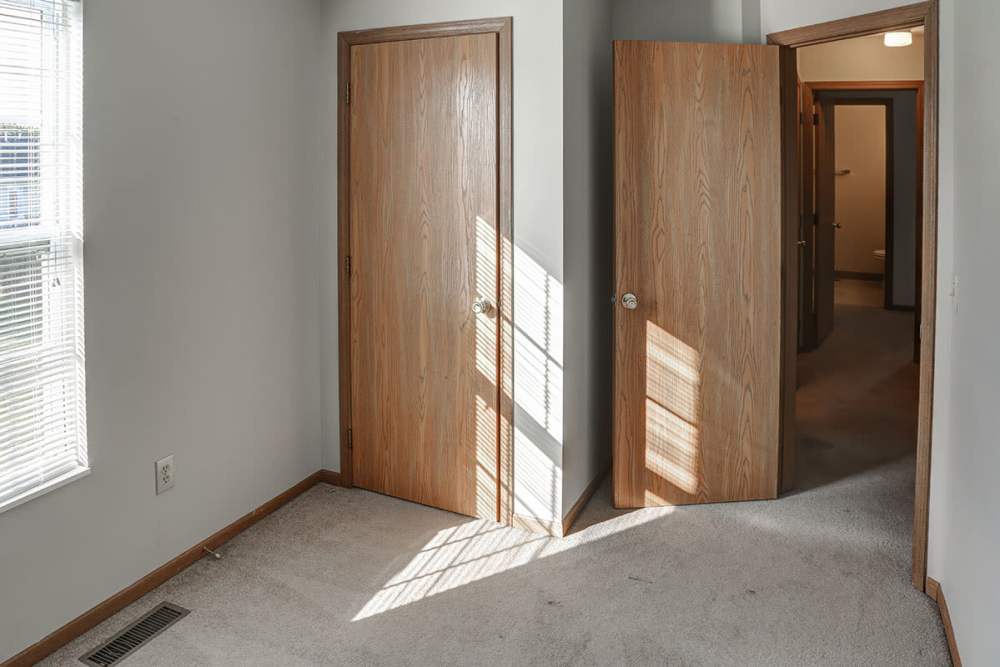Well-lit bedroom with a large window at Ivy Glen in Washington Court House, Ohio 