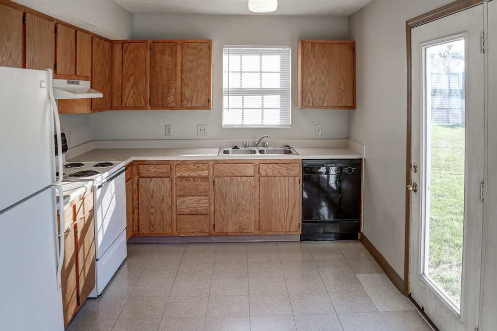 Kitchen with wooden cabinets and energy-efficient appliances at Ivy Glen in Washington Court House, Ohio 