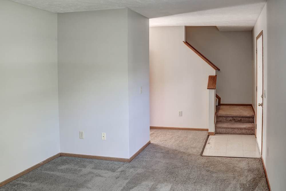 Living room with stairs leading to the above floor at Ivy Glen in Washington Court House, Ohio 
