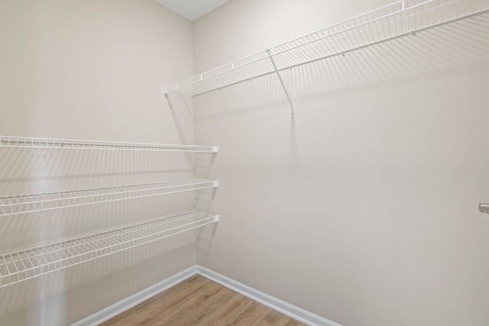 Spacious walk-in closet with wire shelving and wood-style flooring at Kershaw Greene II in Athens, Ohio