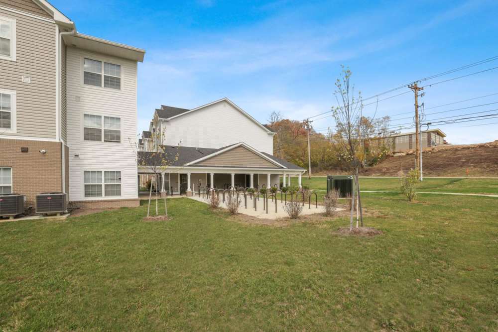 Apartment exterior with covered bike rack area at Kershaw Greene II in Athens, Ohio
