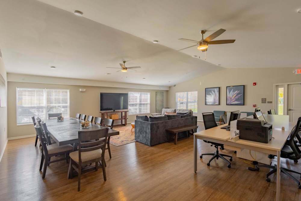 Community room with dining tables, seating area, and workspace at Kershaw Greene II in Athens, Ohio