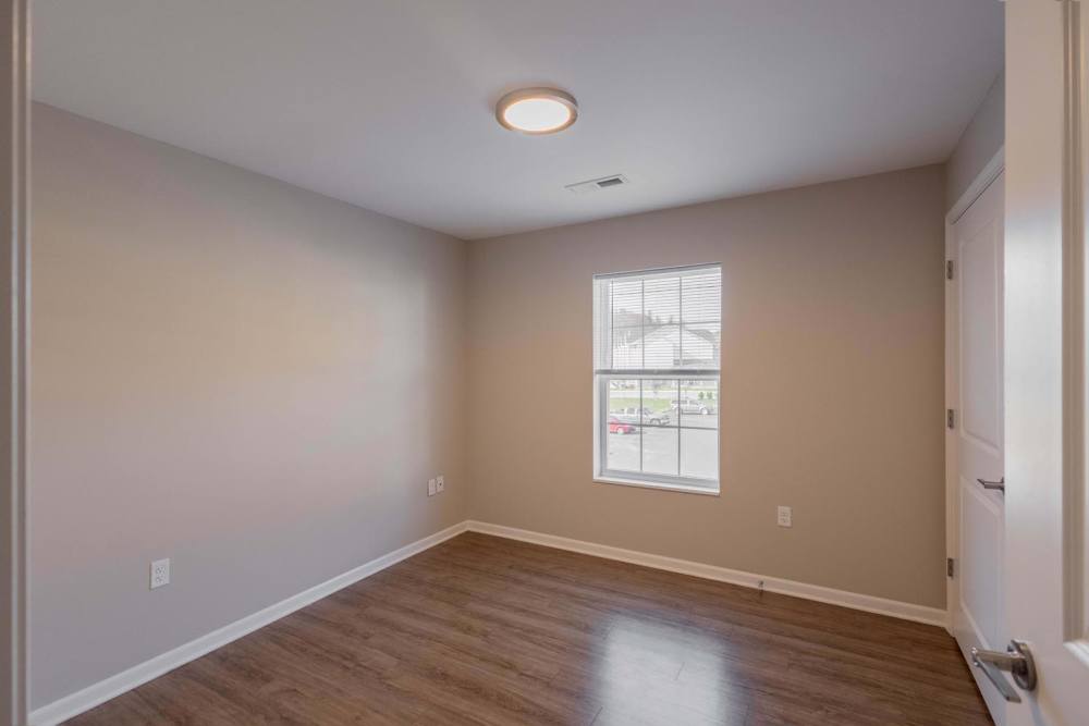 Spacious bedroom with wood-style flooring at Kershaw Greene II in Athens, Ohio