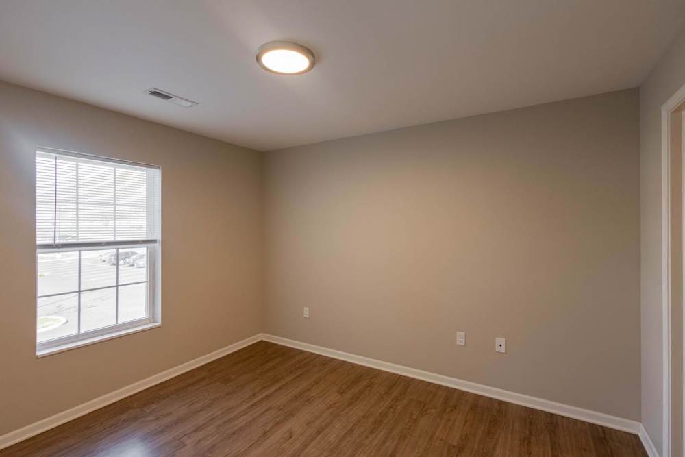 Empty room with wood-style flooring and a window with blinds at Kershaw Greene II in Athens, Ohio
