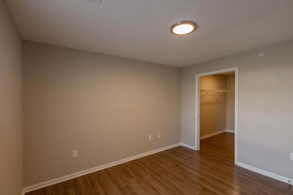 Spacious room with wood-style flooring and a large closet at Kershaw Greene II in Athens, Ohio