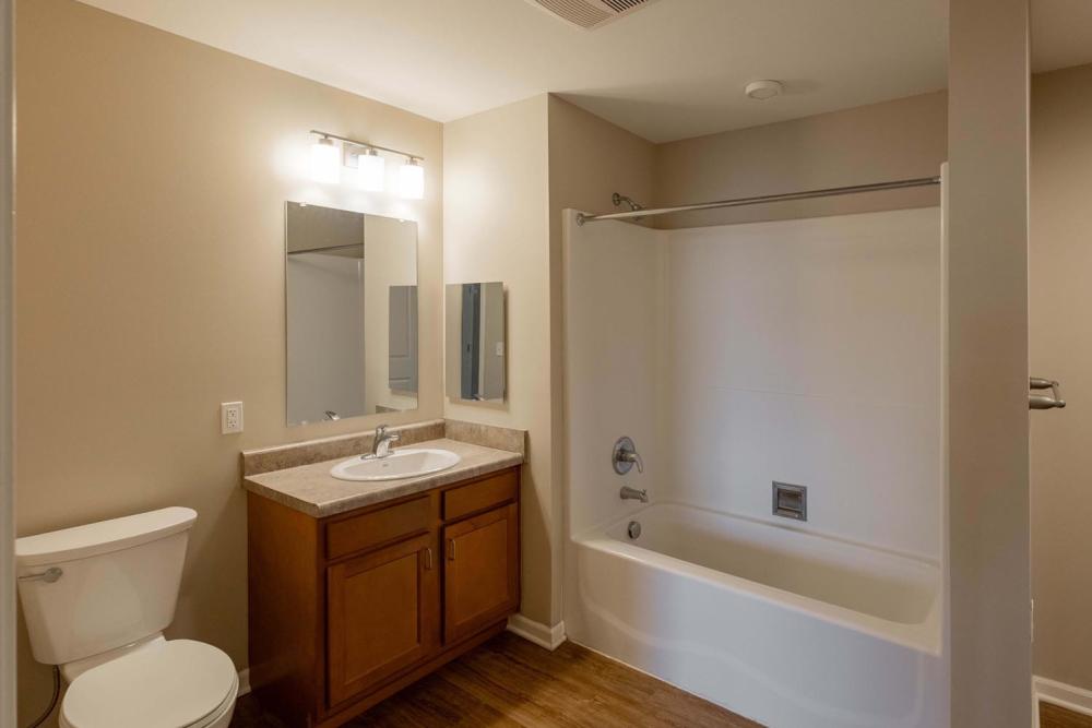 Modern bathroom with wood-style flooring at Kershaw Greene II in Athens, Ohio