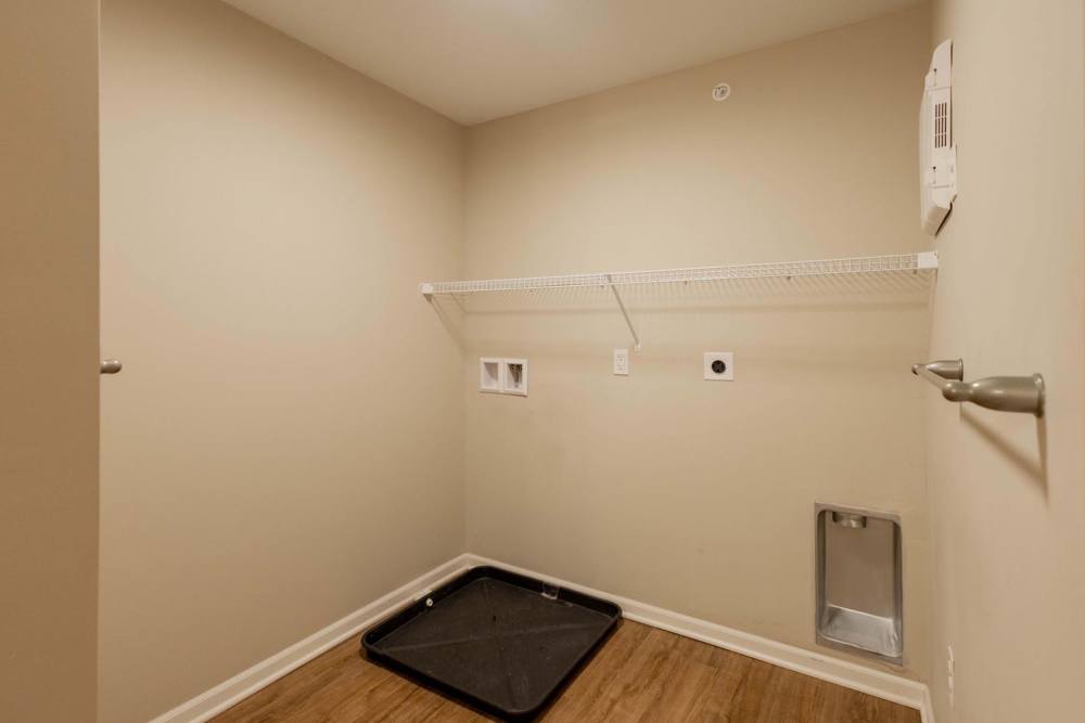 Spacious laundry room with wood-style flooring and pet washing station at Kershaw Greene II in Athens, Ohio