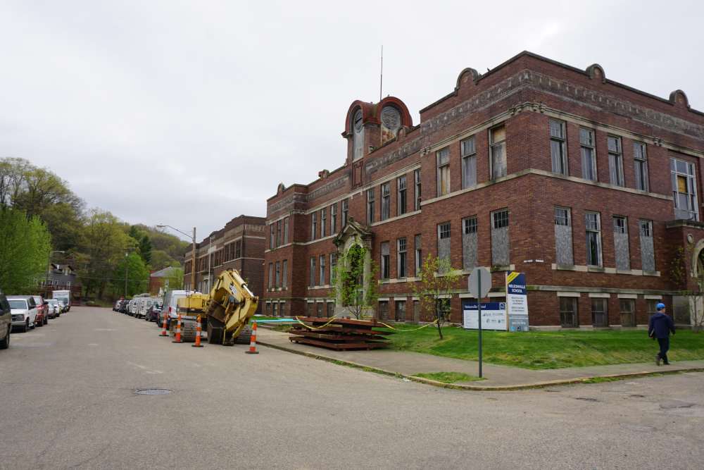 Building with green landscaping and construction equipment nearby at Nelsonville School Commons in Nelsonville, Ohio