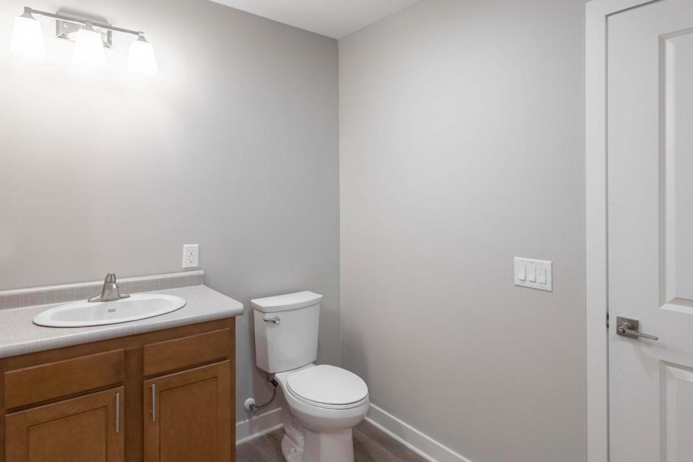 Modern bathroom with wood-style flooring at Sells Greene in Lancaster, Ohio