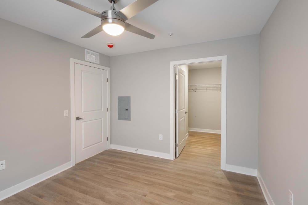Spacious bedroom with wood-style flooring at Sells Greene in Lancaster, Ohio