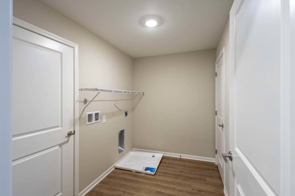 Spacious laundry room with wood-style flooring at Starling Yard in Columbus, Ohio