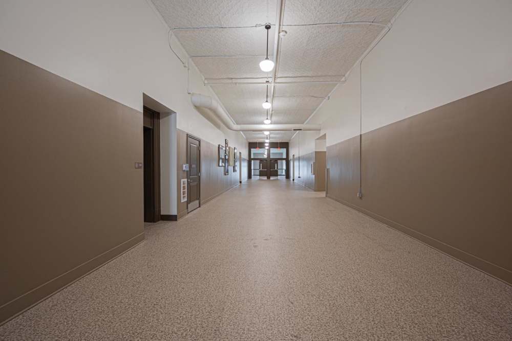 Spacious hallway with polished flooring and natural light from large windows at Starling Yard in Columbus, Ohio