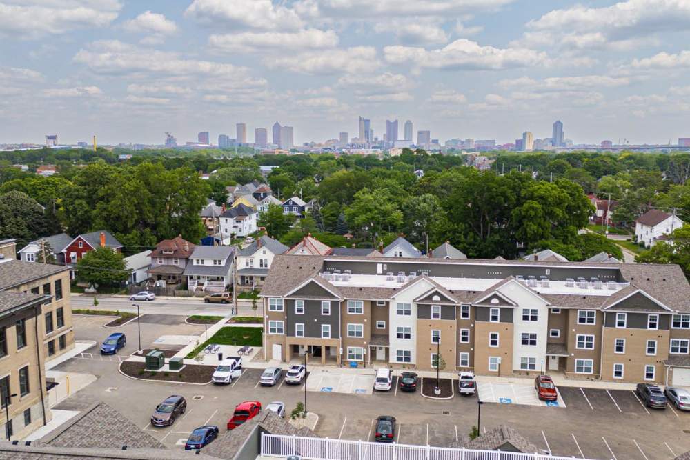 Modern apartment community with landscaped grounds and city skyline in the background at Starling Yard in Columbus, Ohio