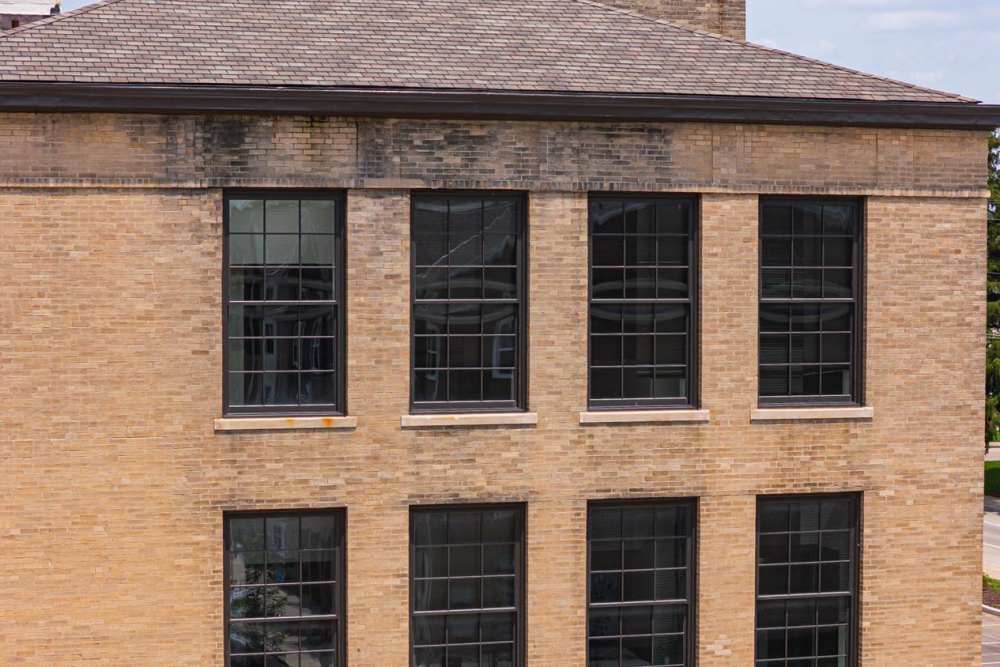 Brick building with large windows and a sloped roof at Starling Yard in Columbus, Ohio