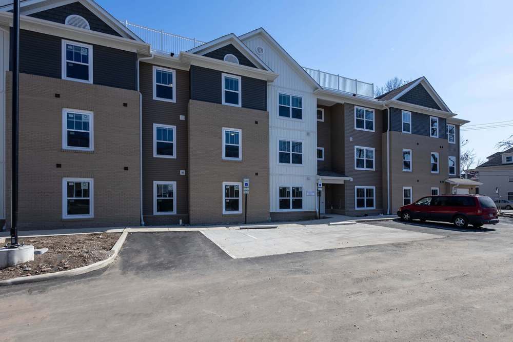 Modern apartment community with a paved parking area at Starling Yard in Columbus, Ohio
