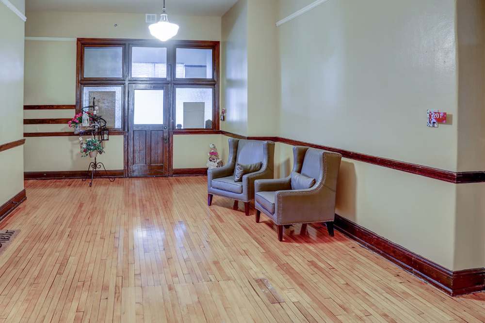Wood flooring with two chairs at entrance at Washington School Apartments in Washington Court House, Ohio
