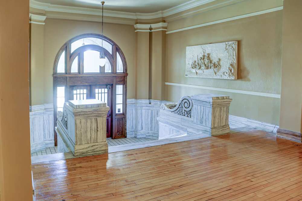 Grand staircase with wooden flooring at Washington School Apartments in Washington Court House, Ohio