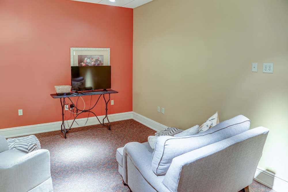 Cozy seating area with TV at Washington School Apartments in Washington Court House, Ohio