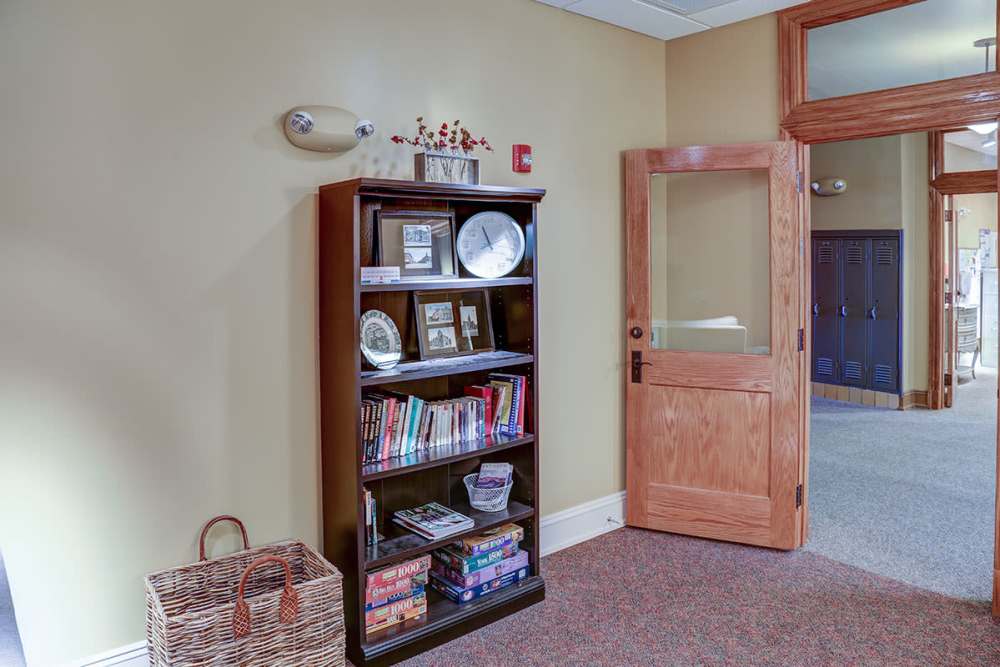 Bookshelf with various books and decor at Washington School Apartments in Washington Court House, Ohio