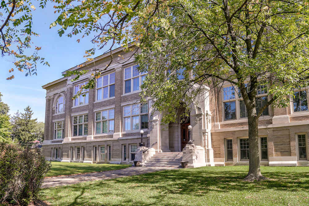 Lush green lawn with historic building at Washington School Apartments in Washington Court House, Ohio