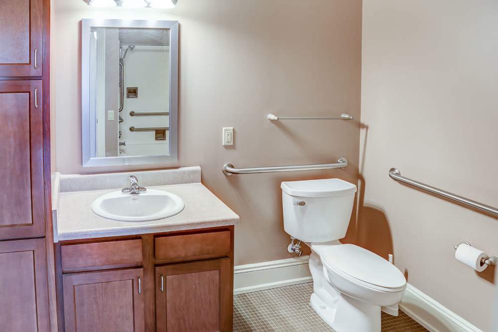 Sleek vanity with mirror and storage at Washington School Apartments in Washington Court House, Ohio