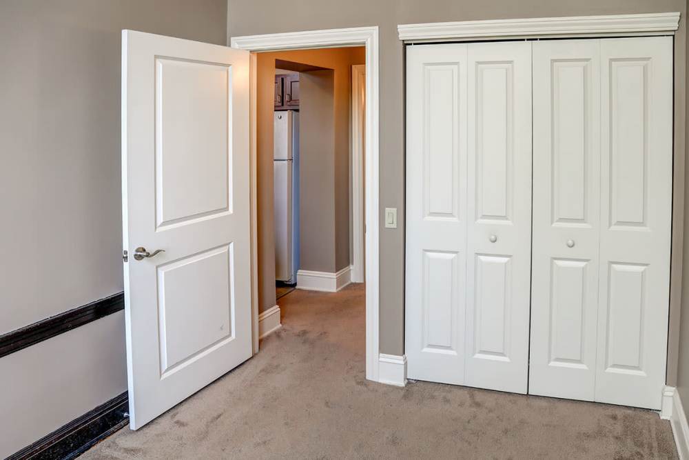Spacious bedroom with closet and doorway at Washington School Apartments in Washington Court House, Ohio