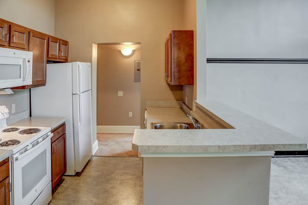 Kitchen with granite countertops and appliances at Washington School Apartments in Washington Court House, Ohio