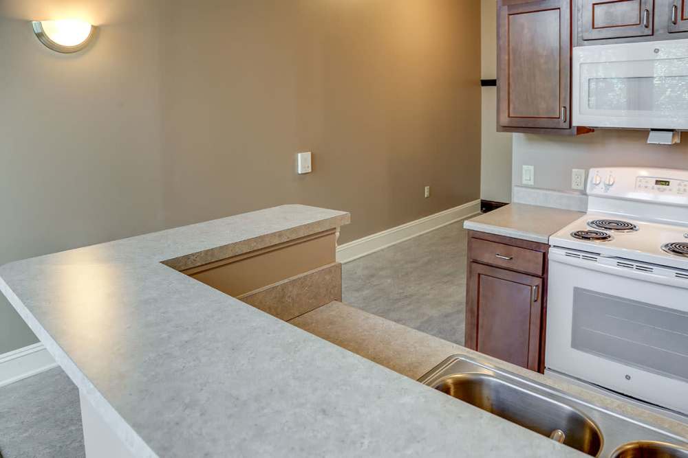 Open layout kitchen with granite countertops at Washington School Apartments in Washington Court House, Ohio