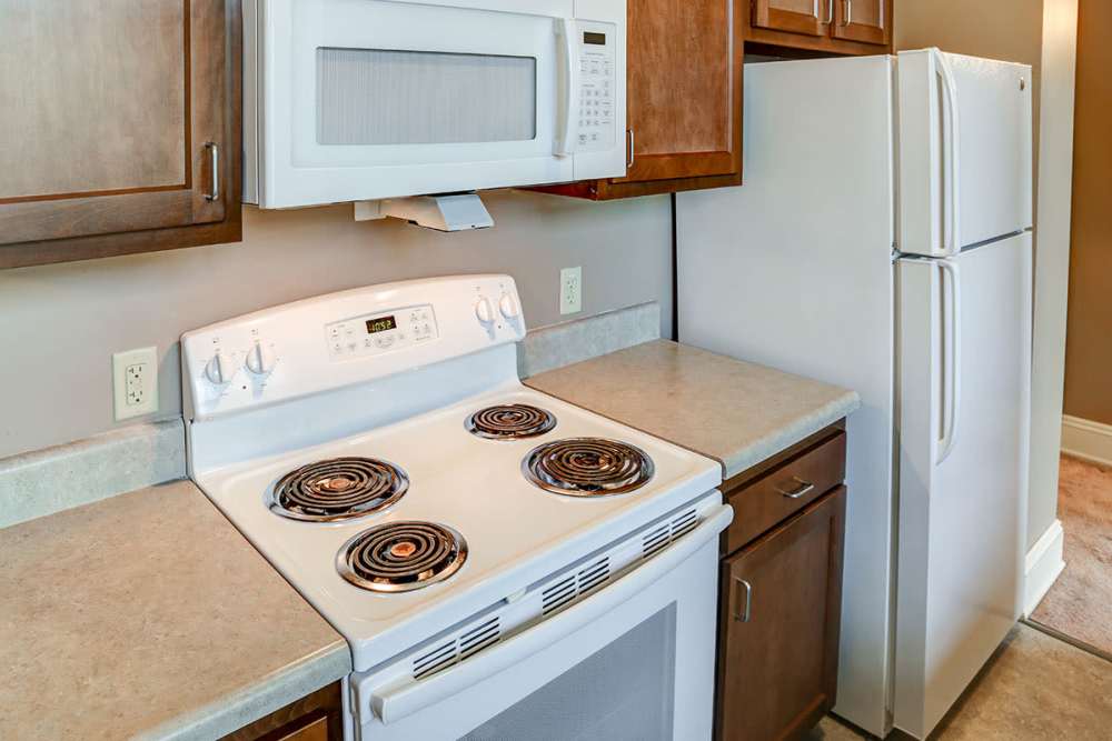 White stove with microwave above at kitchen Washington School Apartments in Washington Court House, Ohio