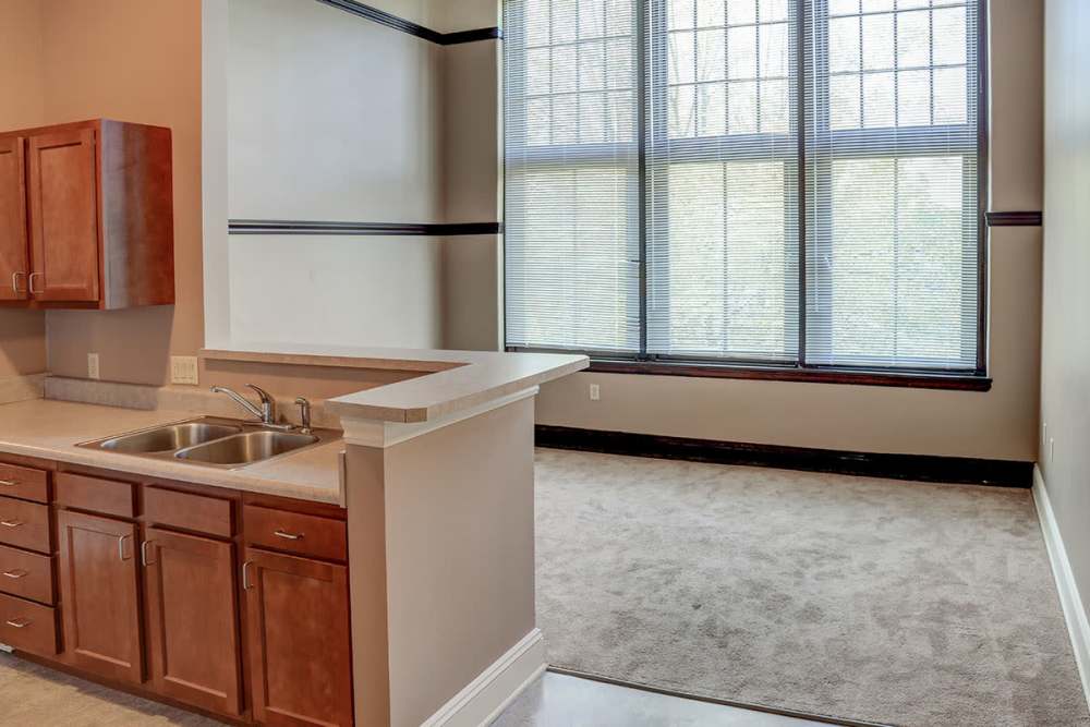 Spacious living area with kitchen at Washington School Apartments in Washington Court House, Ohio