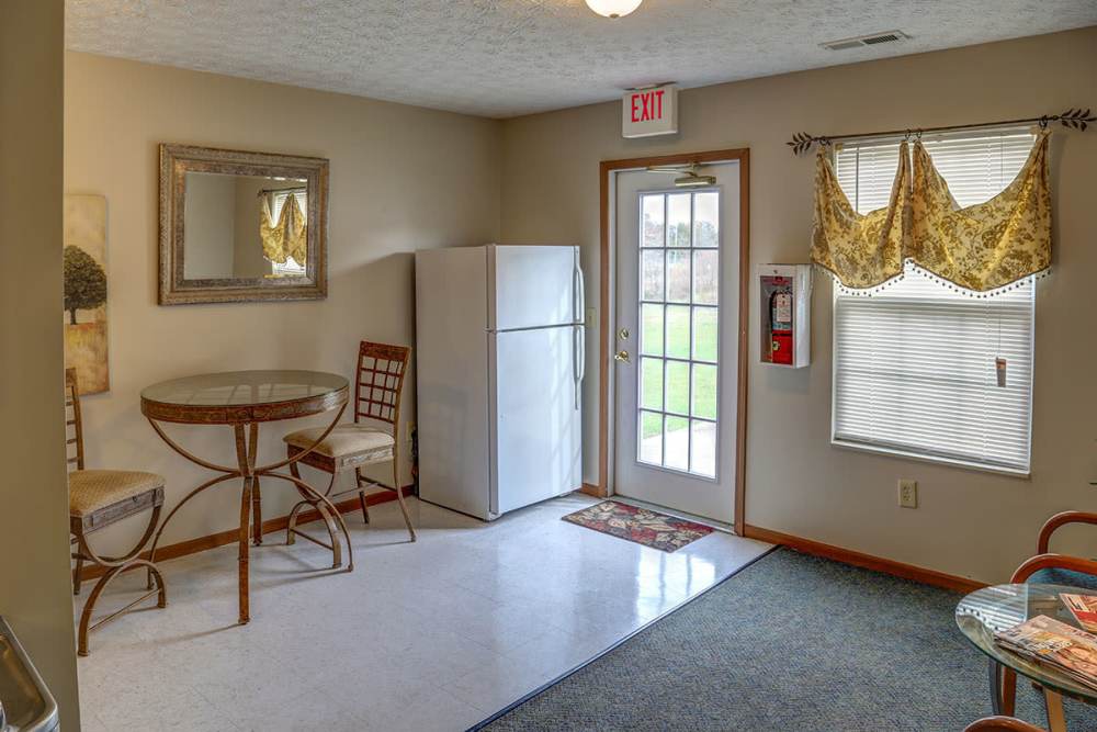 Bright kitchen area with a round table and chairs at Webster Glen in Peebles, Ohio