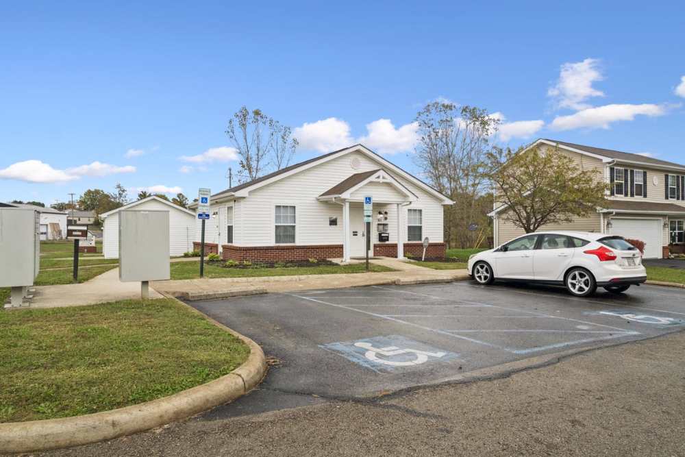 Single-story apartment community with accessible parking at Webster Glen in Peebles, Ohio