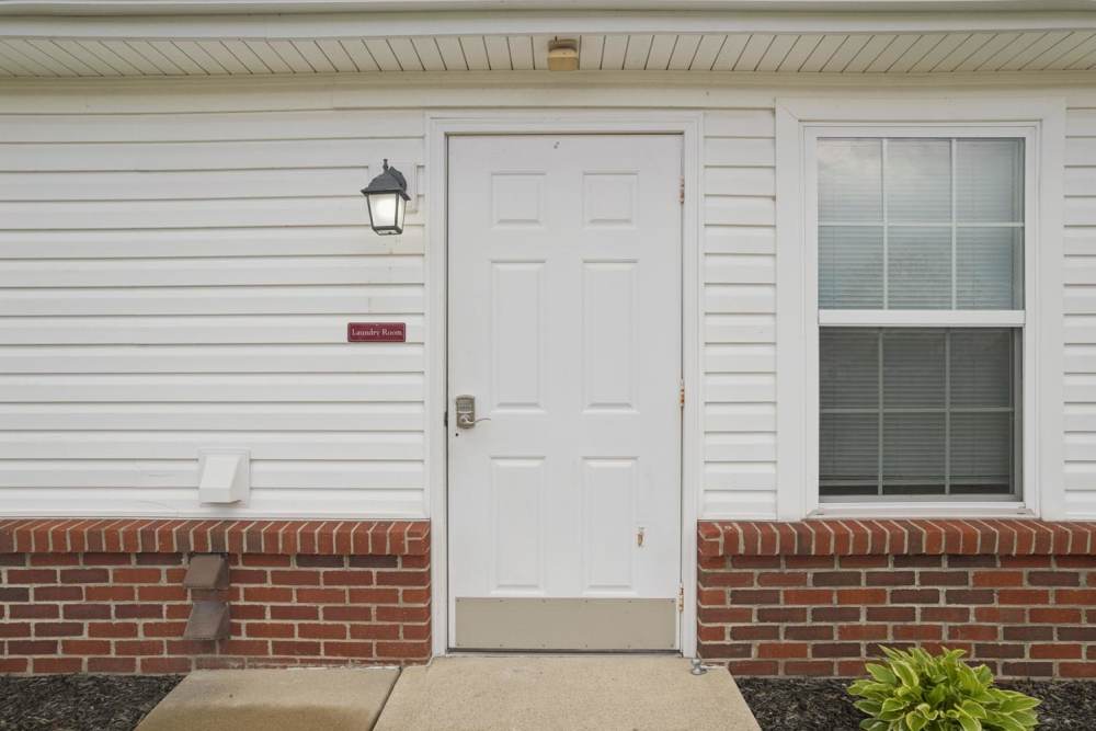 White door with a lantern light and a sign for the laundry room at Webster Glen in Peebles, Ohio