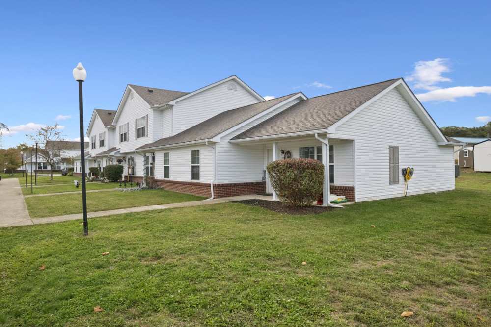 Two-story apartment buildings with green lawns and walkways and well-maintained landscaping at Webster Glen in Peebles, Ohio
