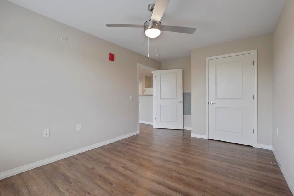 Spacious bedroom with wood-style flooring at Atcheson Place Lofts in Columbus, Ohio