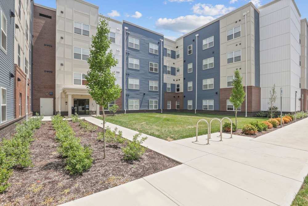 Modern building exterior with landscaped entrance at Atcheson Place Lofts in Columbus, Ohio