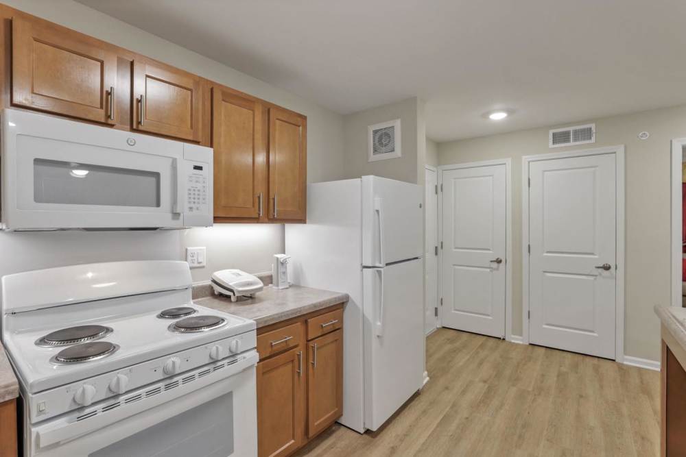 Modern kitchen with wooden cabinets at McKinley Manor in Columbus, Ohio 