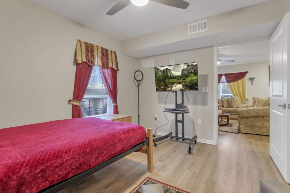 Bedroom with a bed and a TV at McKinley Manor in Columbus, Ohio 